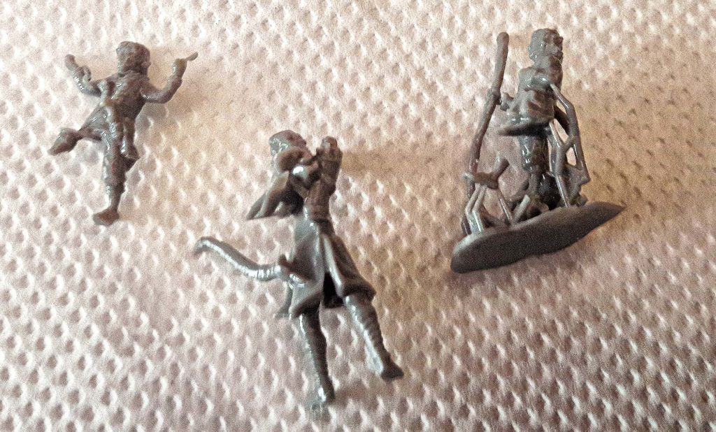 Three damaged 3d models of halflings lying on papertowel