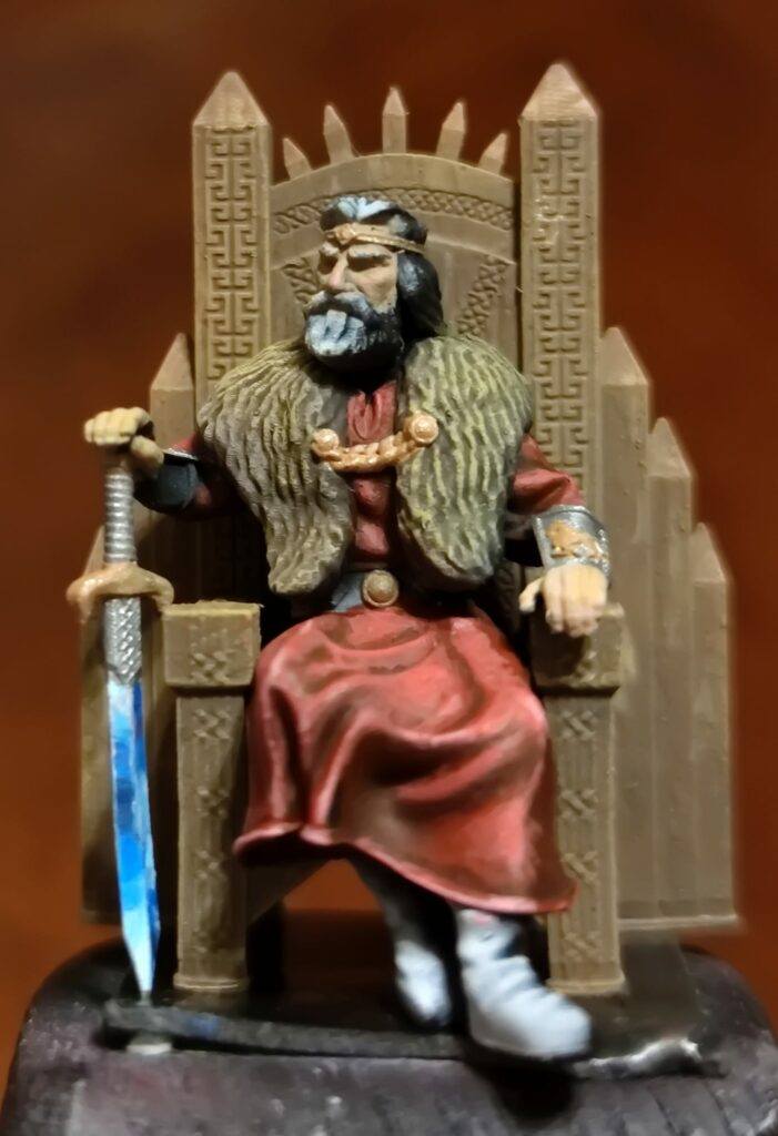 Painted, presupported 3d miniature of the King sits on the throne and bears a sword in the right hand.