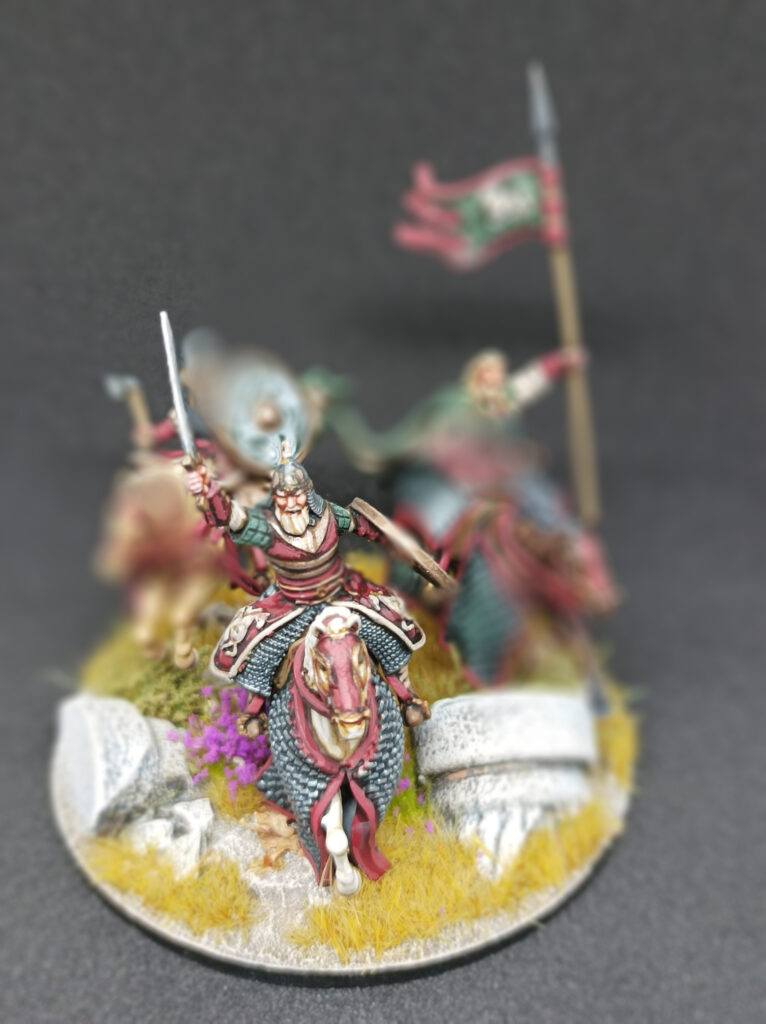 A mounted 3d miniature of the warrior with raised sword.