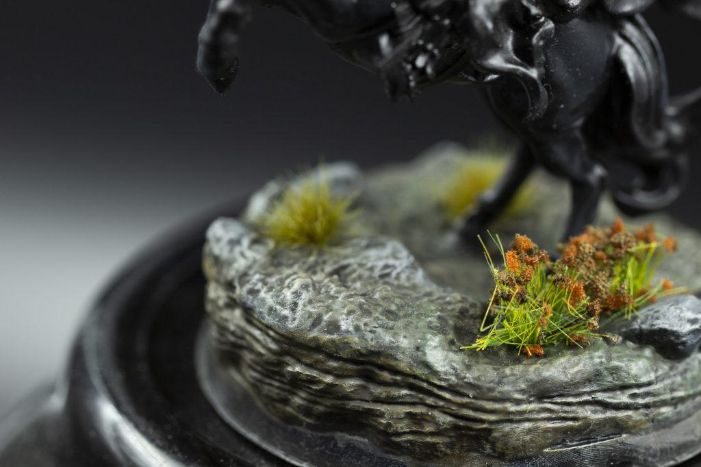 Close-up of the base with the bottom part of the black horse on it. Figurine and base have been printed out of the stl file.